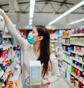 Woman Wearing Mask And Gloves Buying Baby Formula Due To Covid19