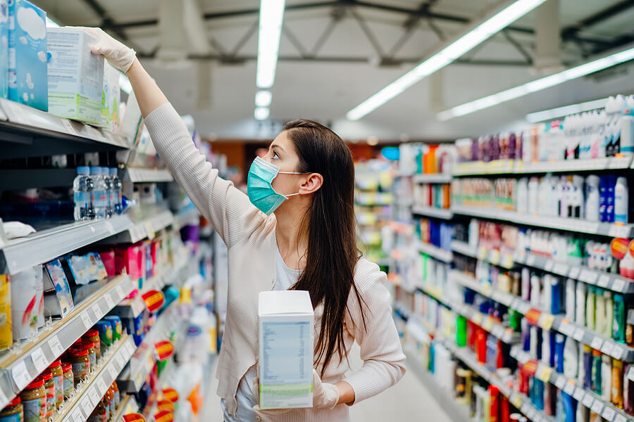 Woman Wearing Mask And Gloves Buying Baby Formula Due To Covid19