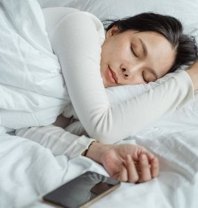 women sleeping on side in bed