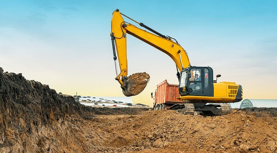 A large industrial construction excavator of yellow color on the construction site in a quarry for quarrying.